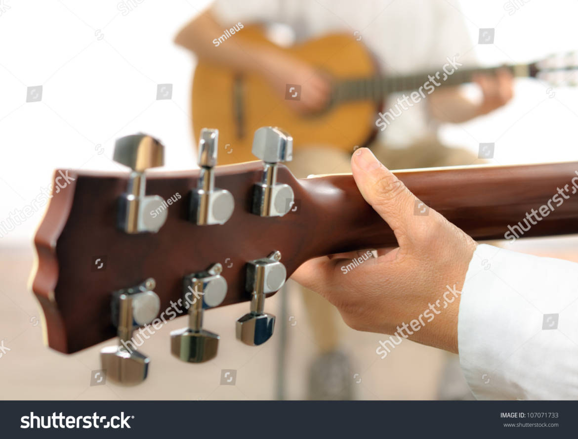 stock-photo-guitar-lesson-or-two-musicians-playing-together-shot-from-behind-one-guitar-with-shallow-focus-107071733.jpg