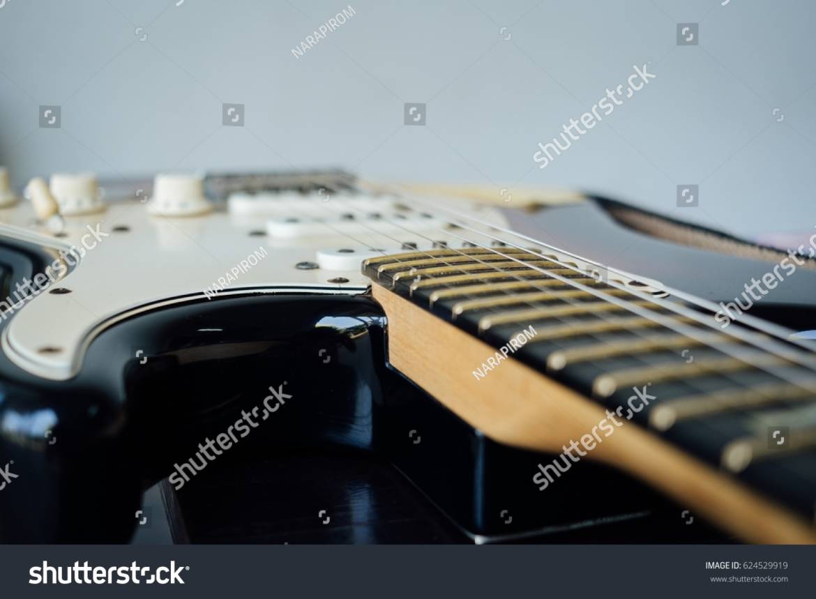 stock-photo-guitar-on-table-624529919.jpg