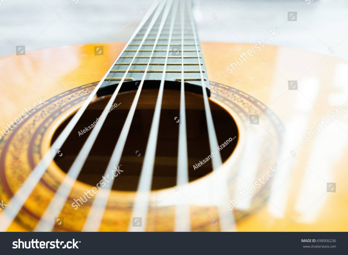 stock-photo-strings-of-bright-yellow-guitar-698906236.jpg